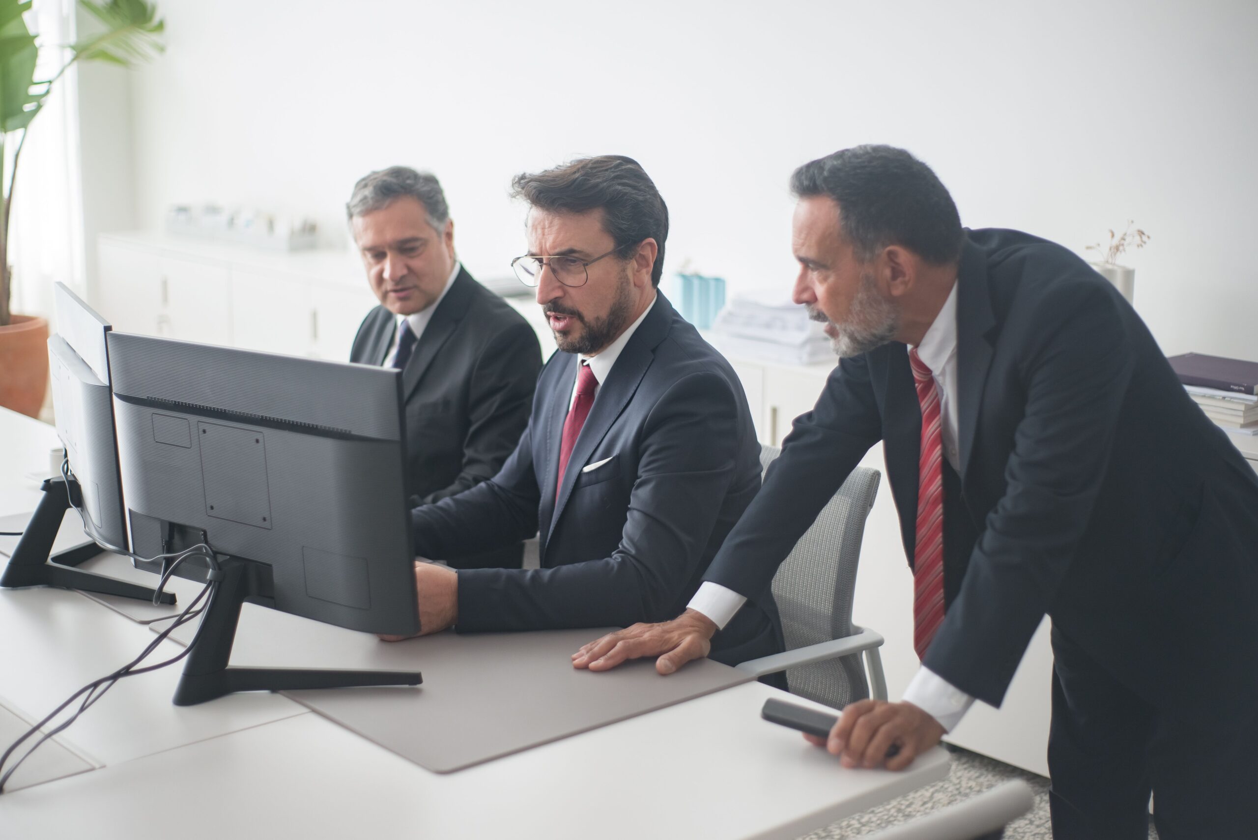 Professionals collaborating on a project in a modern office setting.
